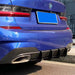 Glossy black blade diffuser for BMW 3-series G20 M-Pakke installed on blue car rear bumper