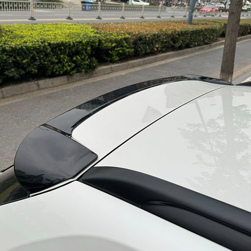 Glossy black rear spoiler for BMW X1 E84 2012-2015 trim upgrade, installed on white car roofline