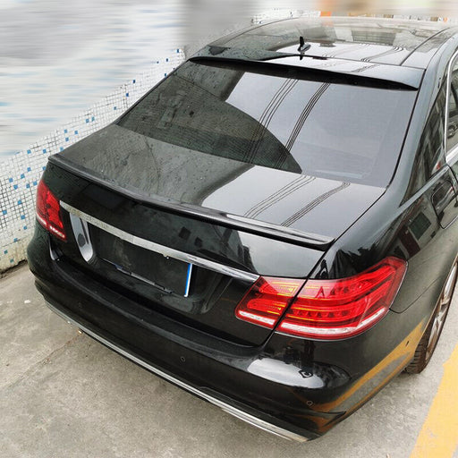 Black roof spoiler wing mounted on Mercedes W212 trunk, blank sort finish installed