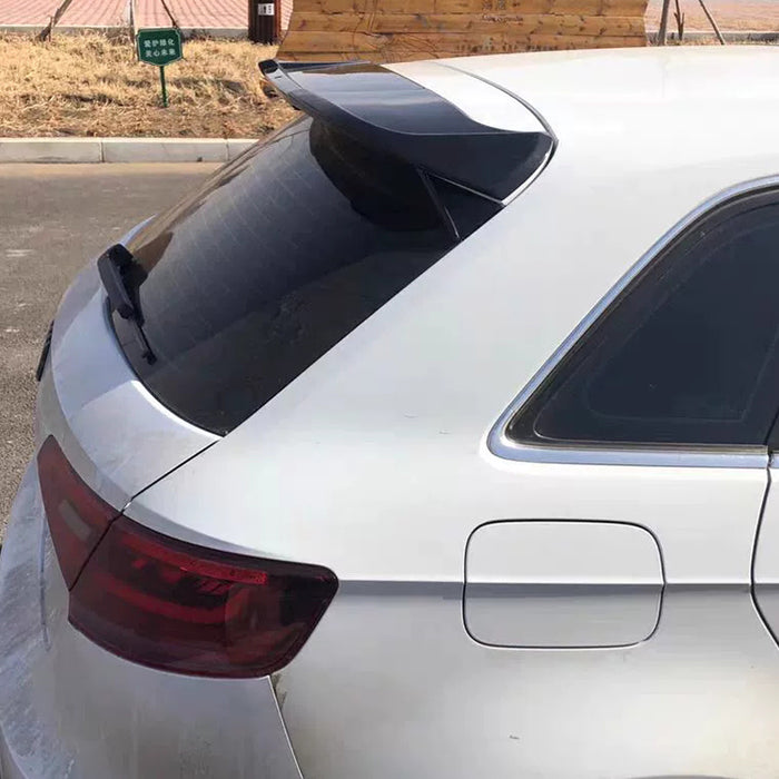 Black dynamic roof spoiler installed on white Audi A3 8V hatchback rear exterior