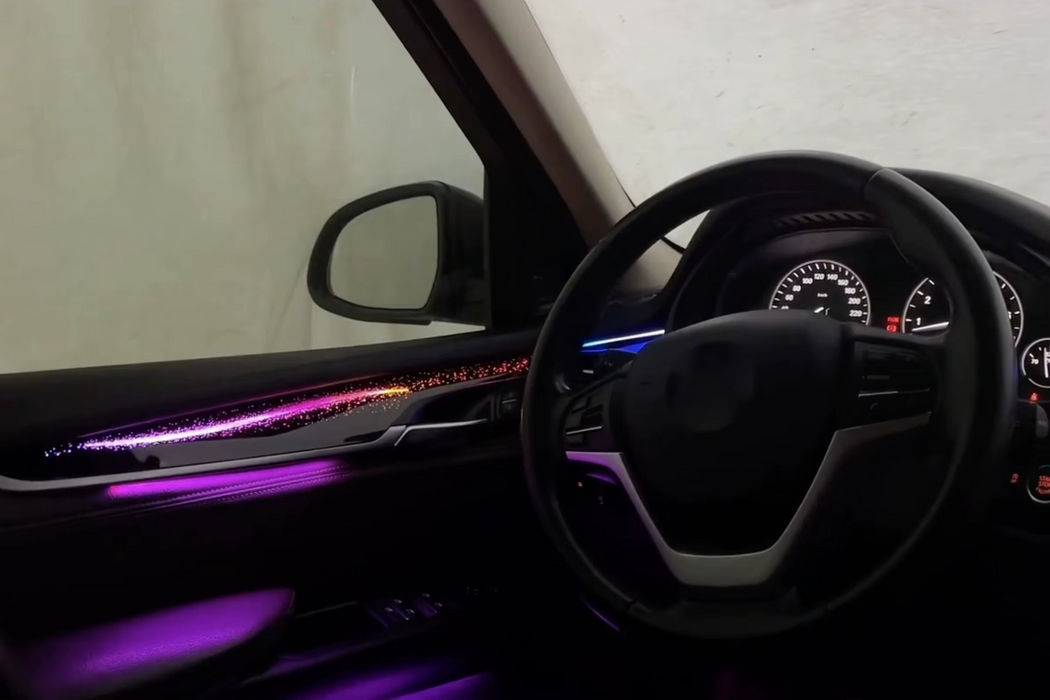 BMW X5 F15 ambient lighting package installation with purple and blue LED accent lights throughout dashboard and door trim